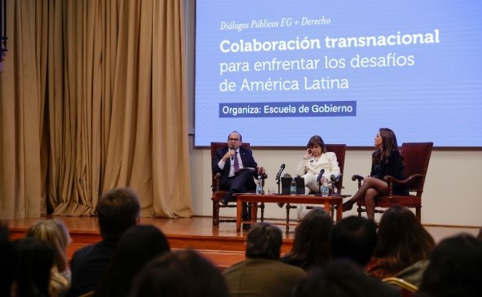Foto de un panel de tres personas frente a un público